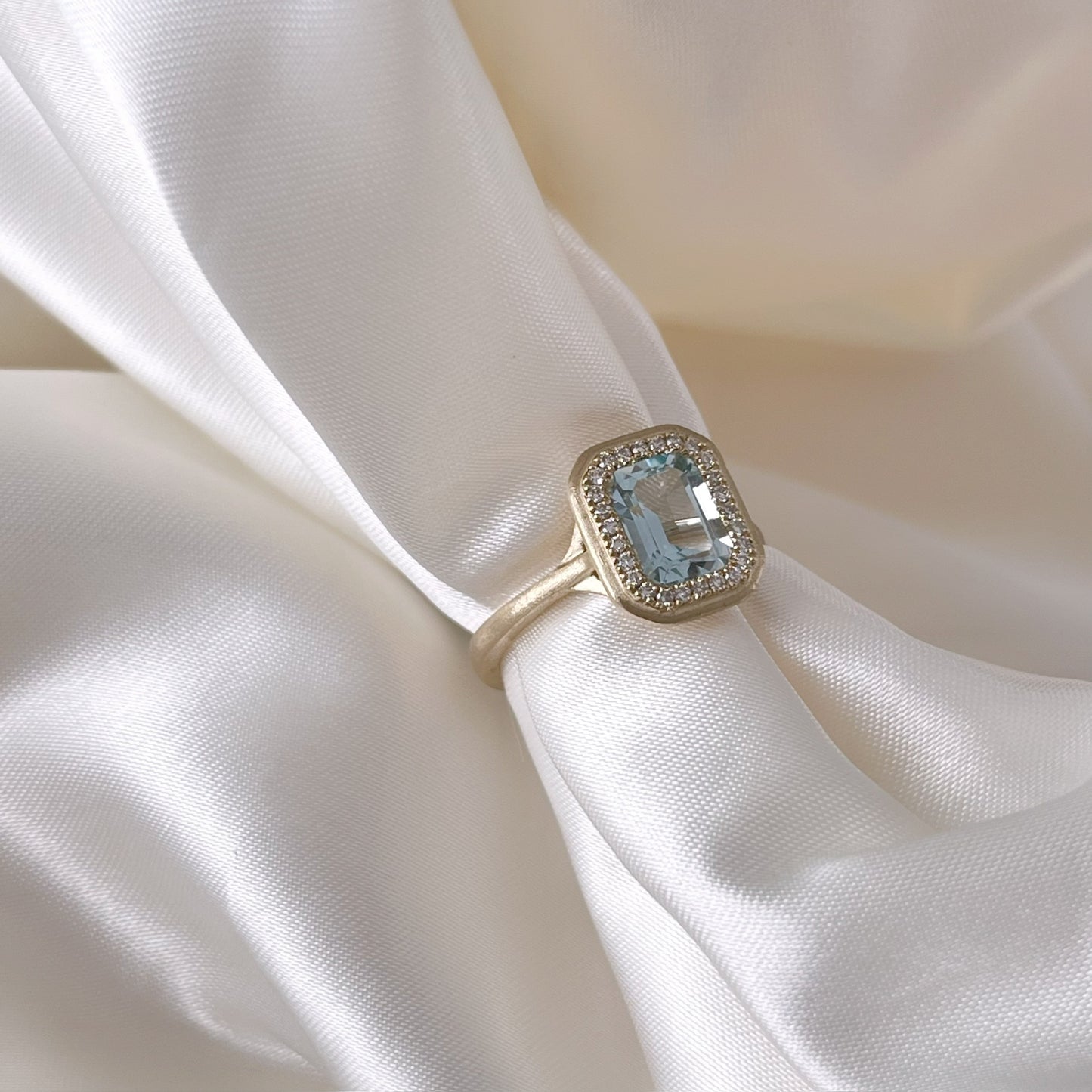 Emerald Cut Sky Blue Topaz and Diamond Halo Ring