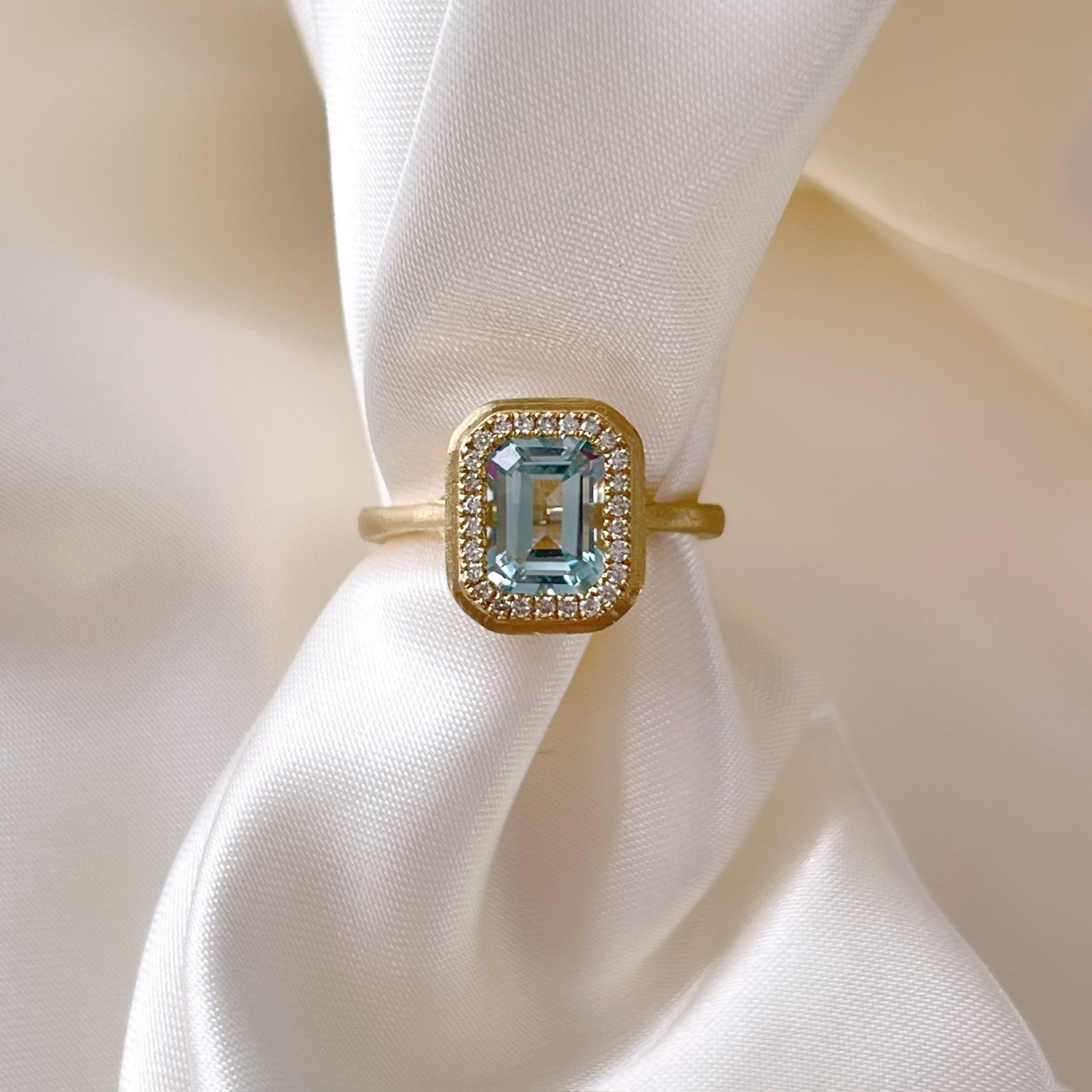 Emerald Cut Sky Blue Topaz and Diamond Halo Ring